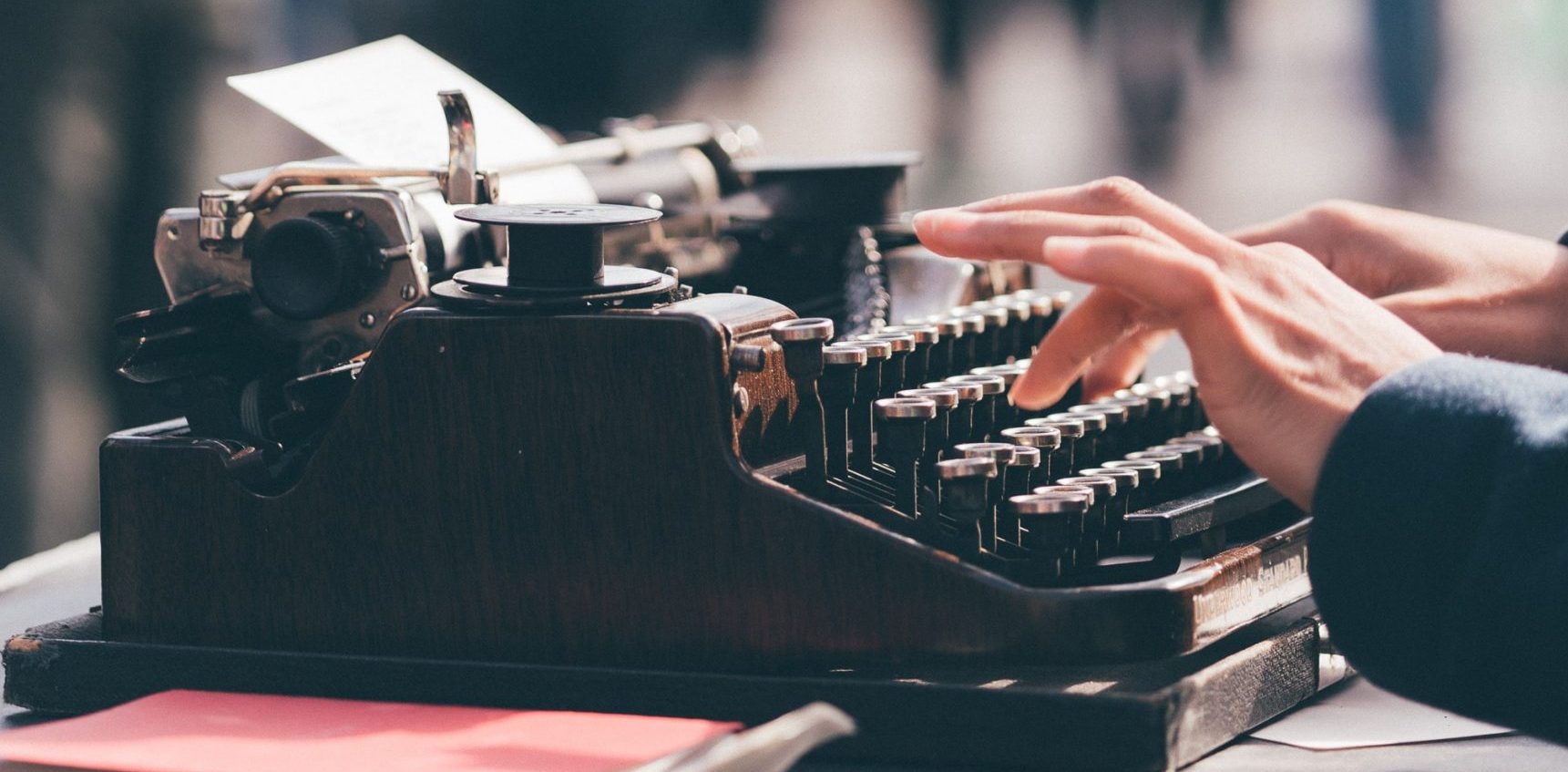 persons fingers on typewriter