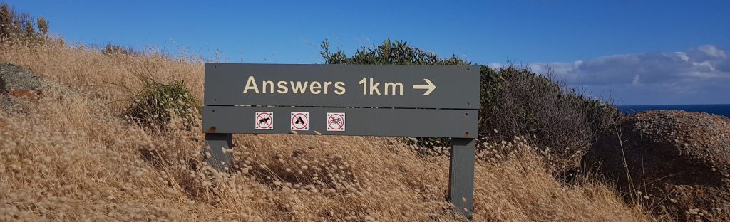Sign with arrow saying answers in this direction