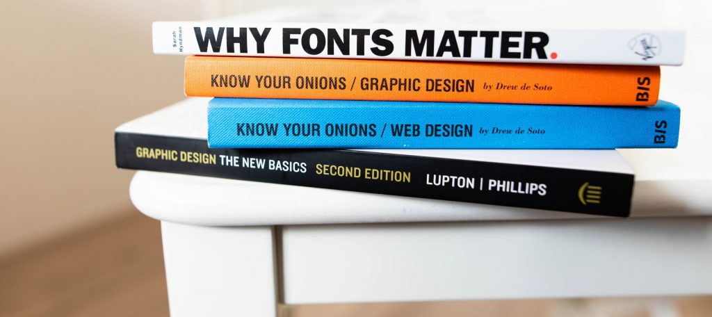 Stack of books, top book titled WHY FONTS MATTER