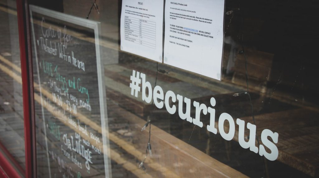Window sign saying #becurious